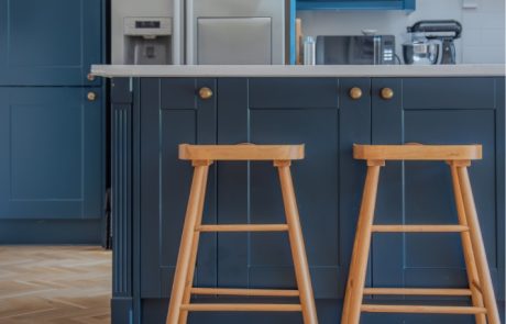 9NEWROAD-8 Kitchen with navy cabinets and glass lantern pendant lights.