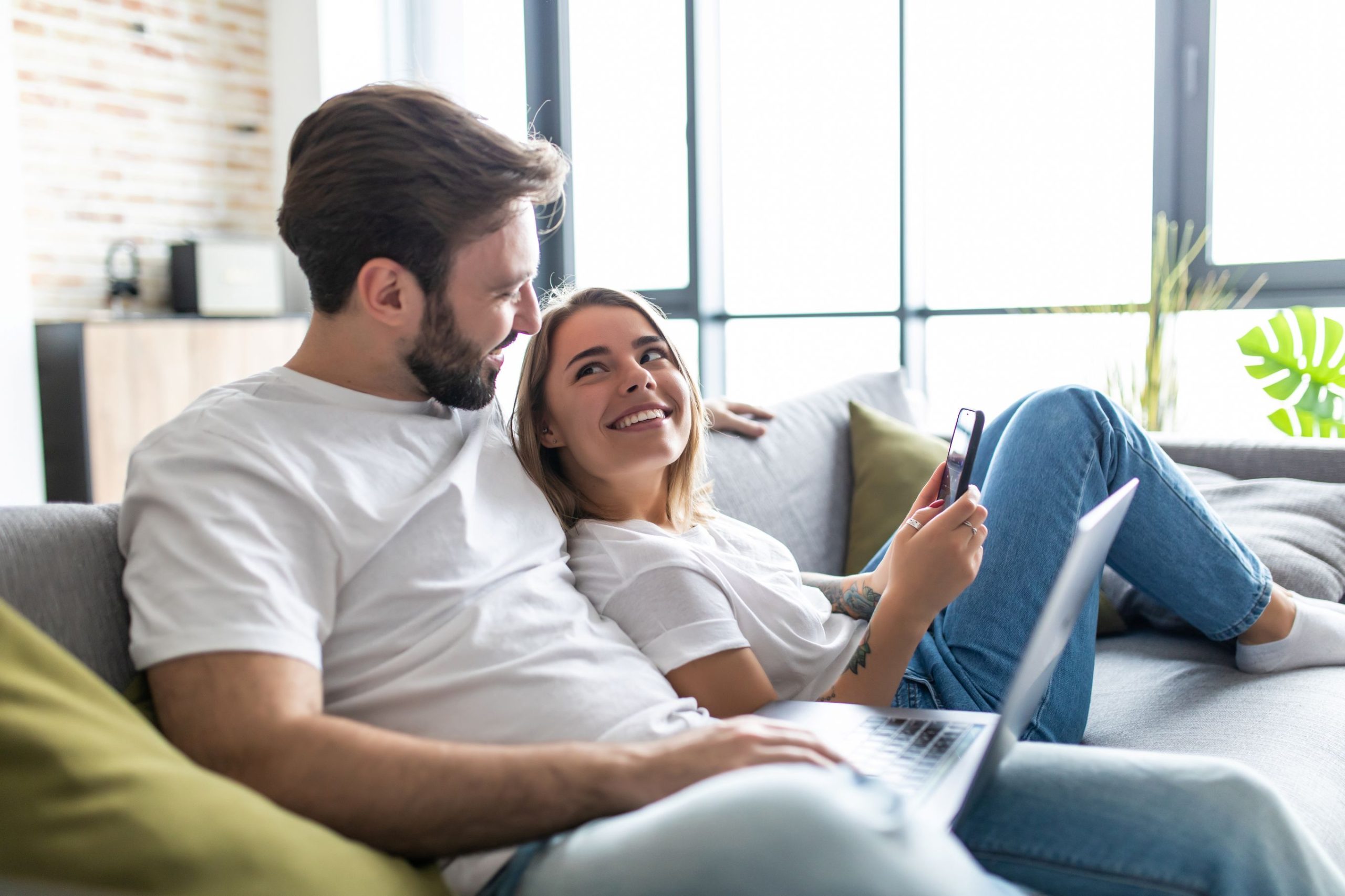 Planning Permission Couple on sofa using electronic devices