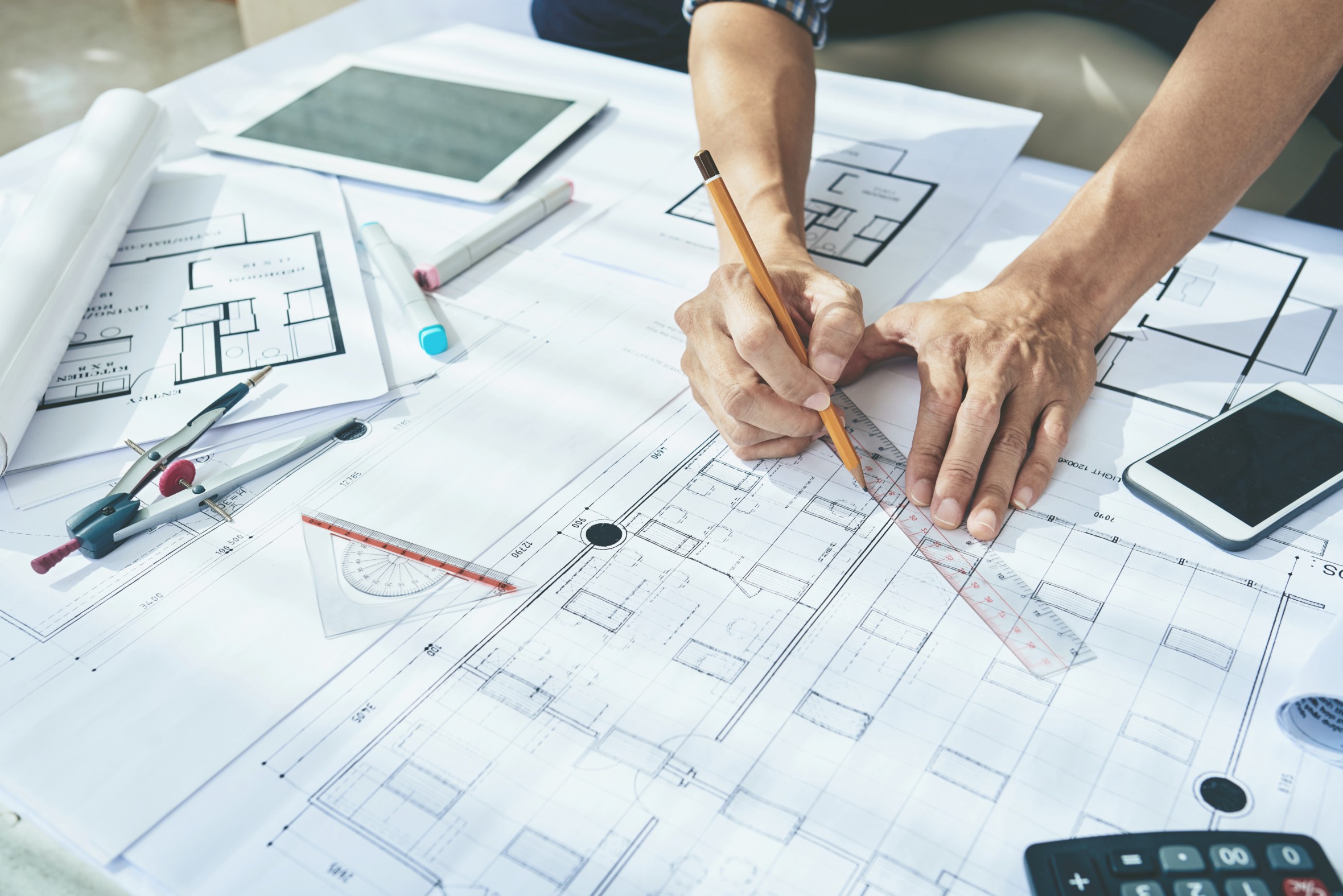 Architect Drawing An architect drawing and measuring with a ruler