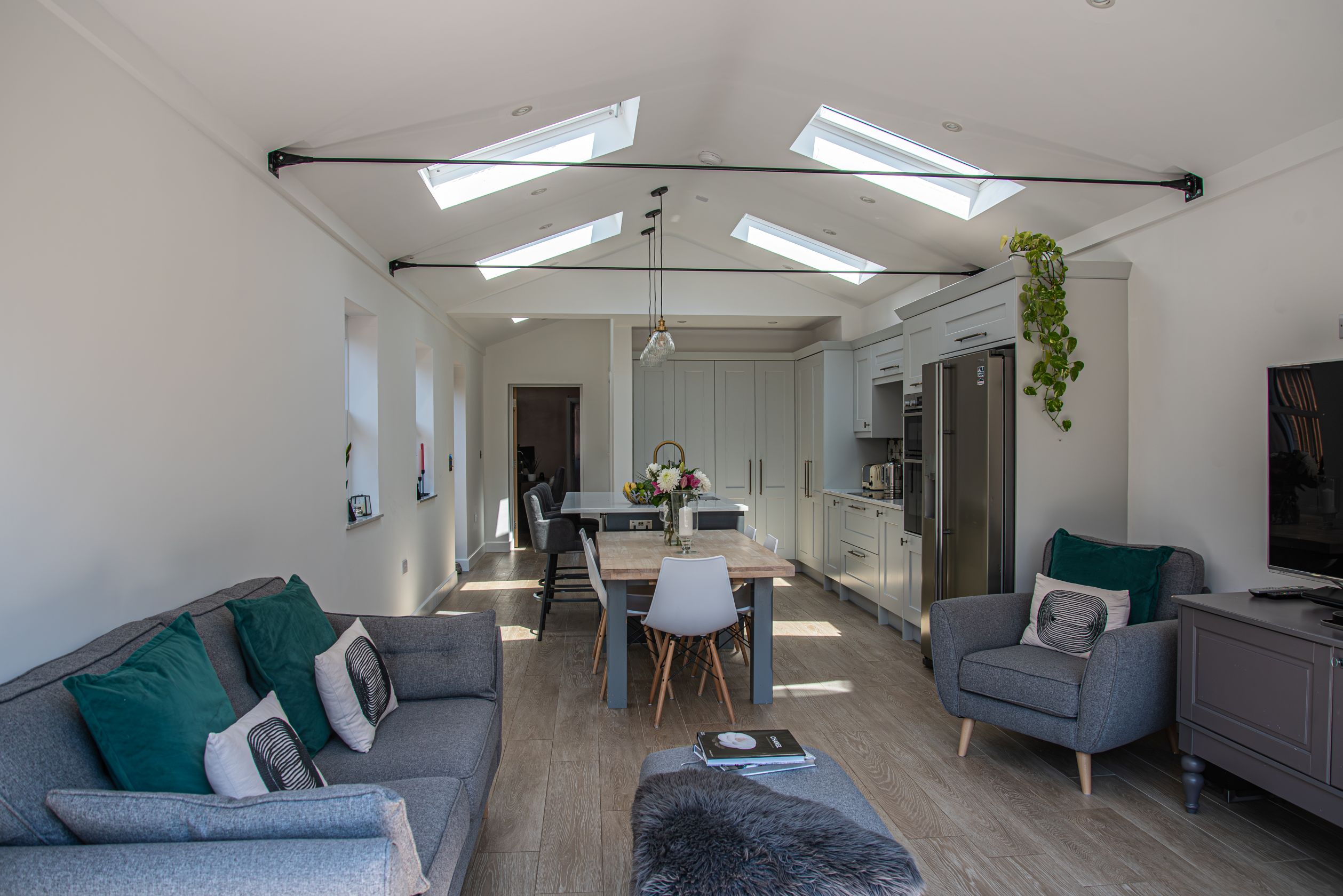 15 New Road View of spacious open-plan living area with sloped ceiling and ceiling windows